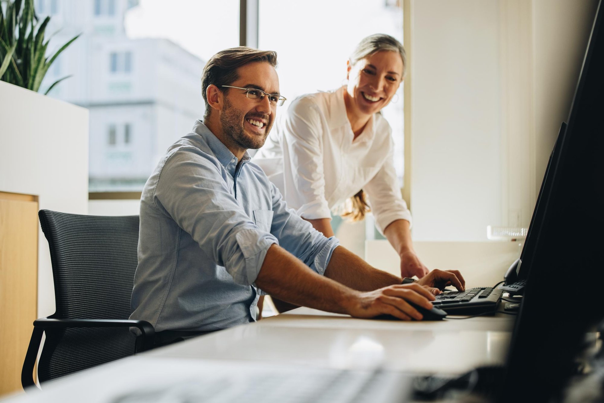 Man sitting next to standing woman
